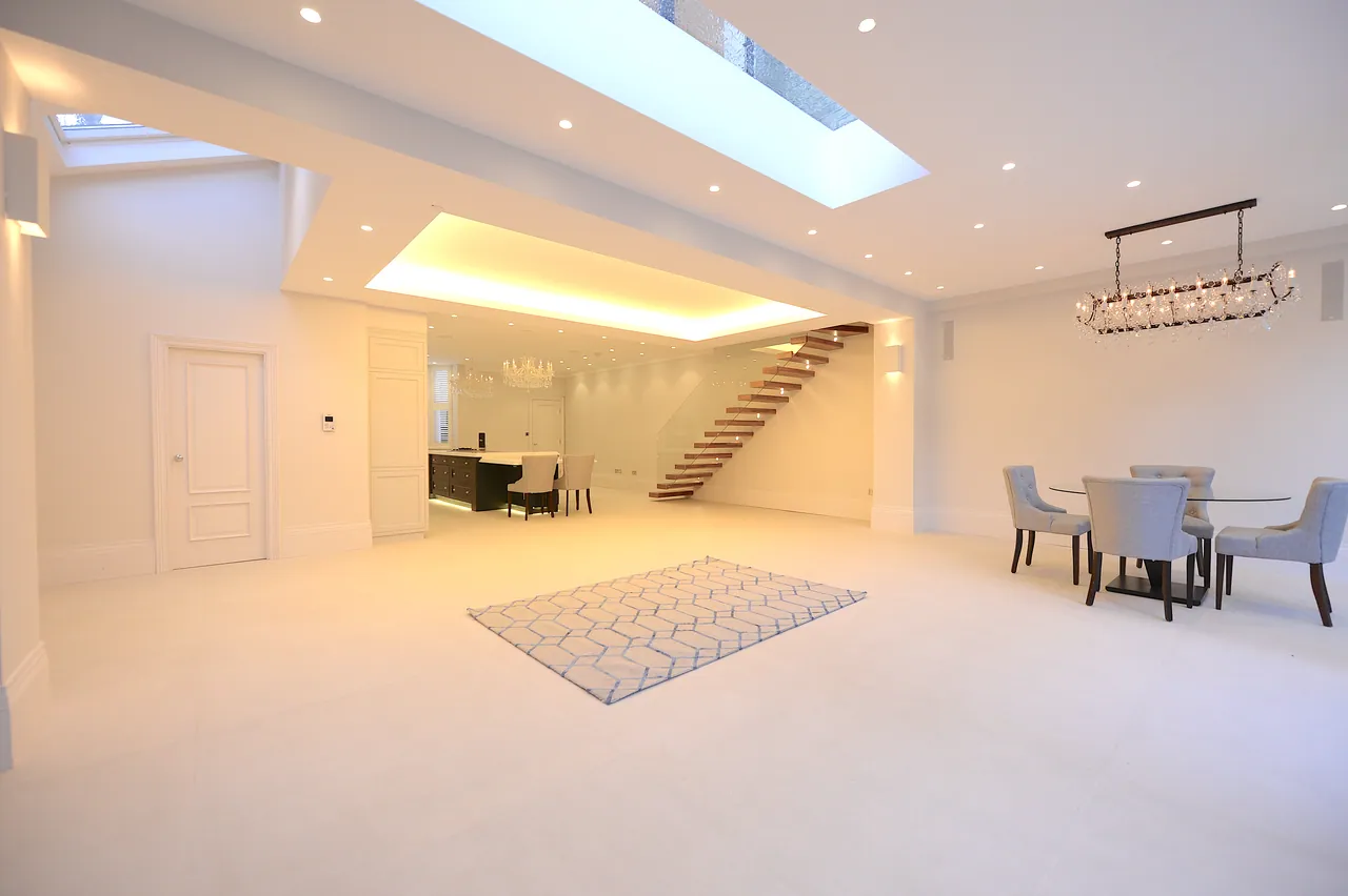 Open-plan living and dining room lit by a long rooflight