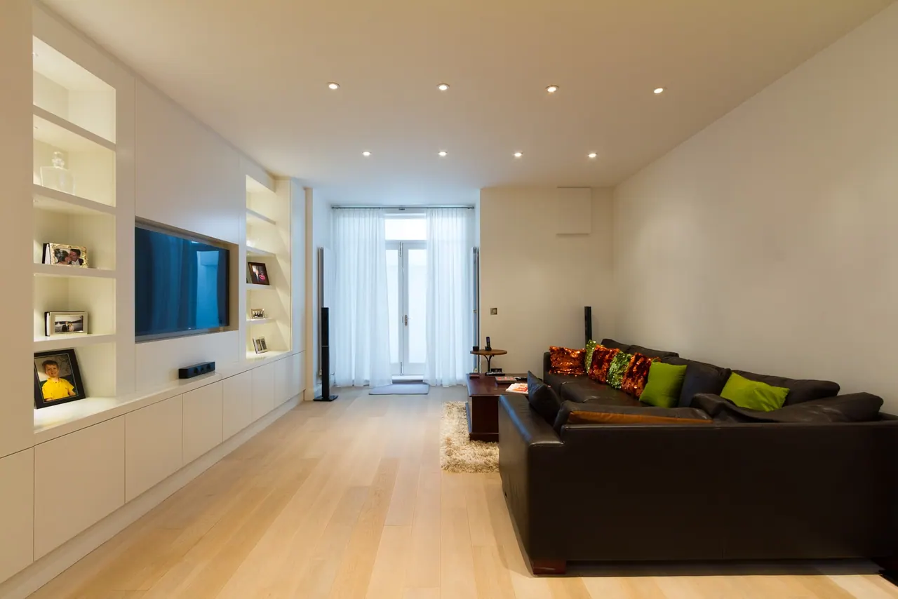 Living room with fitted joinery the full length of the wall