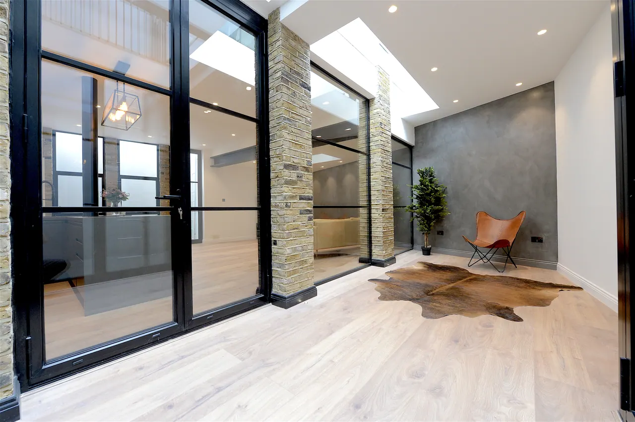 Full-height glazing to the courtyard, framed in black steel